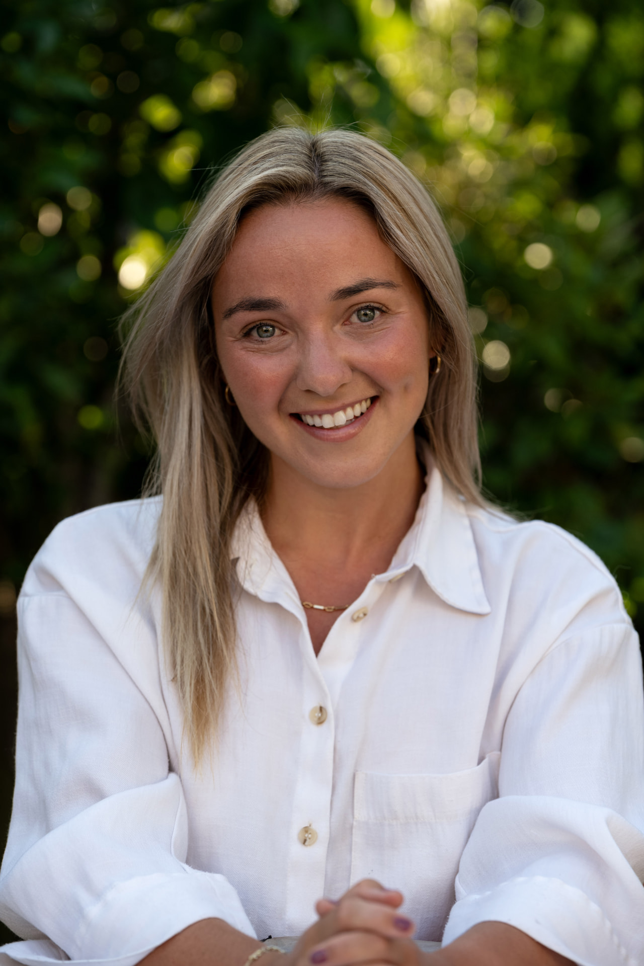 Ruby Cole, specialist tutor and children's coach, smiling outdoors.